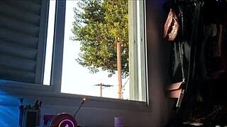 Watch this Brazilian brunette showing off her big natural tits at the window!