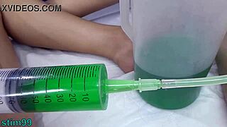 Lesbian PISS TUBE Shoves Urine Into Uterus Peehole!