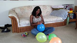 ebony beauty inflates giant balloons teasing her huge tits in french fetish play