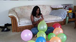 ebony beauty inflates giant balloons teasing her huge tits in french fetish play