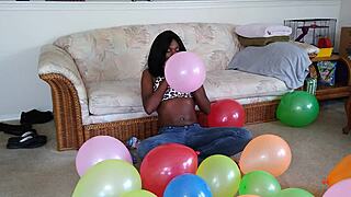 ebony beauty inflates giant balloons teasing her huge tits in french fetish play
