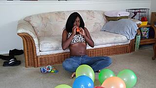ebony beauty inflates giant balloons teasing her huge tits in french fetish play