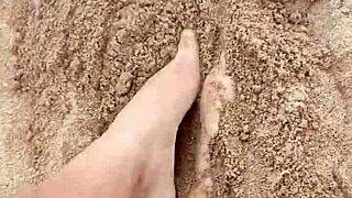 Bare feet sink into sand exploring every sensory texture and feel step by step