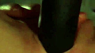 Paige Ashley straps on black dildo to pound lesbian Scarlett March bent over bed