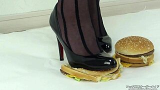 woman crushes hamburger under stockings and heels