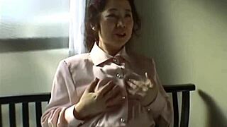 Japanese mommy rams vibrator deep in hairy pussy