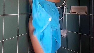 Lady Oils Legs in Public Shower Hidden Cam