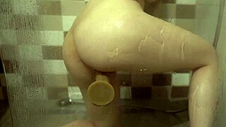 Big tits babe fucks dildo hard in steamy shower