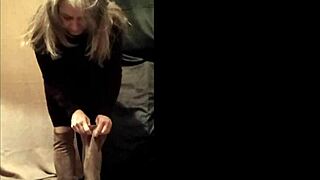 french slave bound in leather harness exhibits during outdoor autoseance