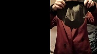 french slave bound in leather harness exhibits during outdoor autoseance