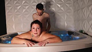Intimate kissing session inside bubbling jacuzzi bath