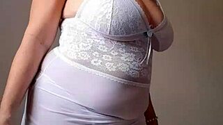 blonde milf's huge natural tits spill from lingerie