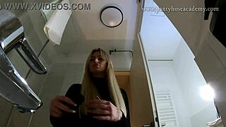 big tits big ass hot blonde babe in pantyhose and high heels with a miniskirt does a striptease in the bathroom