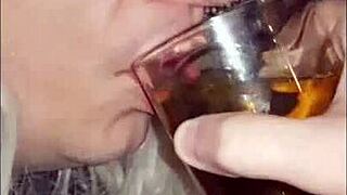 Girlfriend makes blindfolded crossdresser drink his own pee!