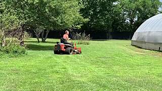 Neighbor riding lawnmower naked outdoors