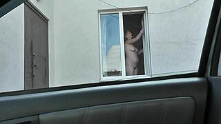 Nude woman neighbor sexy mature milf without panties and bra washes windows her apartment a taxi driver watches from car solo naked in public peeping outdoor outside publicly big natural tits pussy