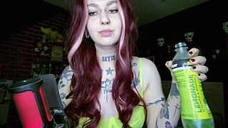 Sexy alternative redhead drinking soda and burping