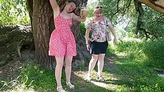 two women lift skirts and pee on the road