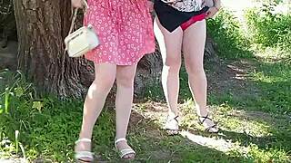 two women lift skirts and pee on the road