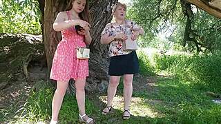 two women lift skirts and pee on the road